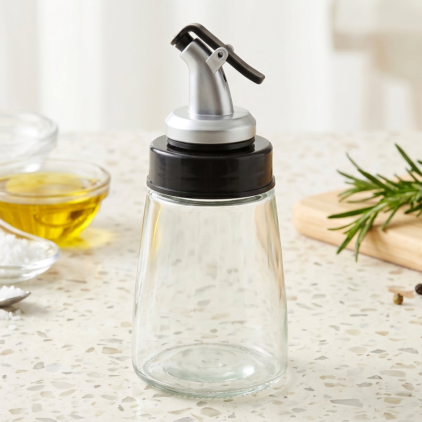Refillable glass oil dispenser for olive oil and condiments with easy pour spout.