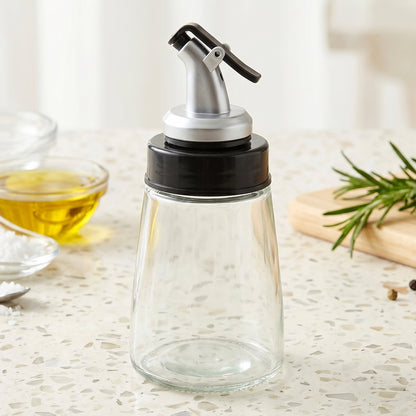 Refillable glass oil dispenser for olive oil and condiments with easy pour spout.