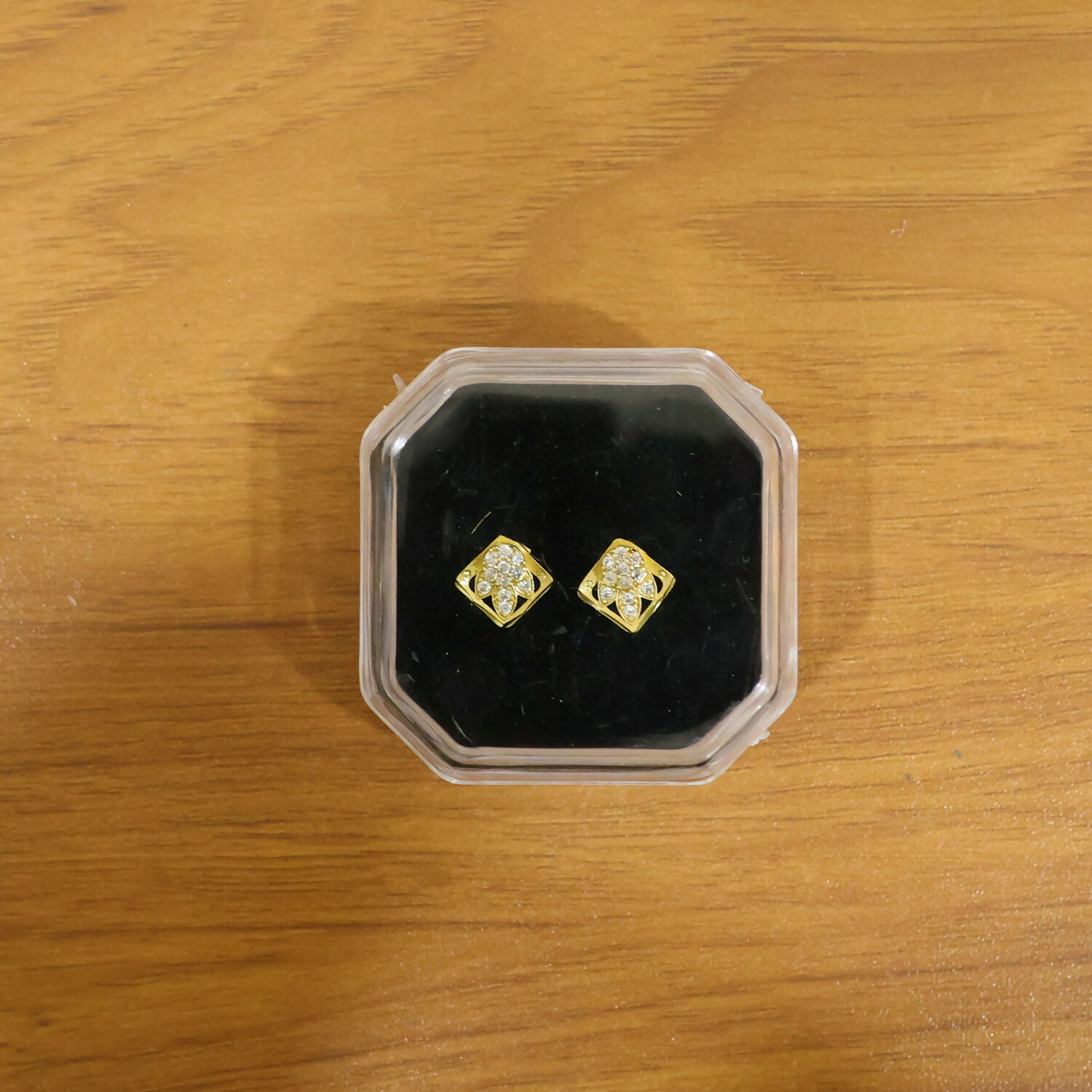 Elegant gold stud earrings with floral and stone design, suitable for everyday wear
