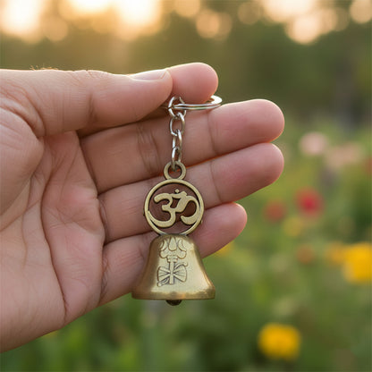 Close-up of the Om symbol on the metal temple bell keychain