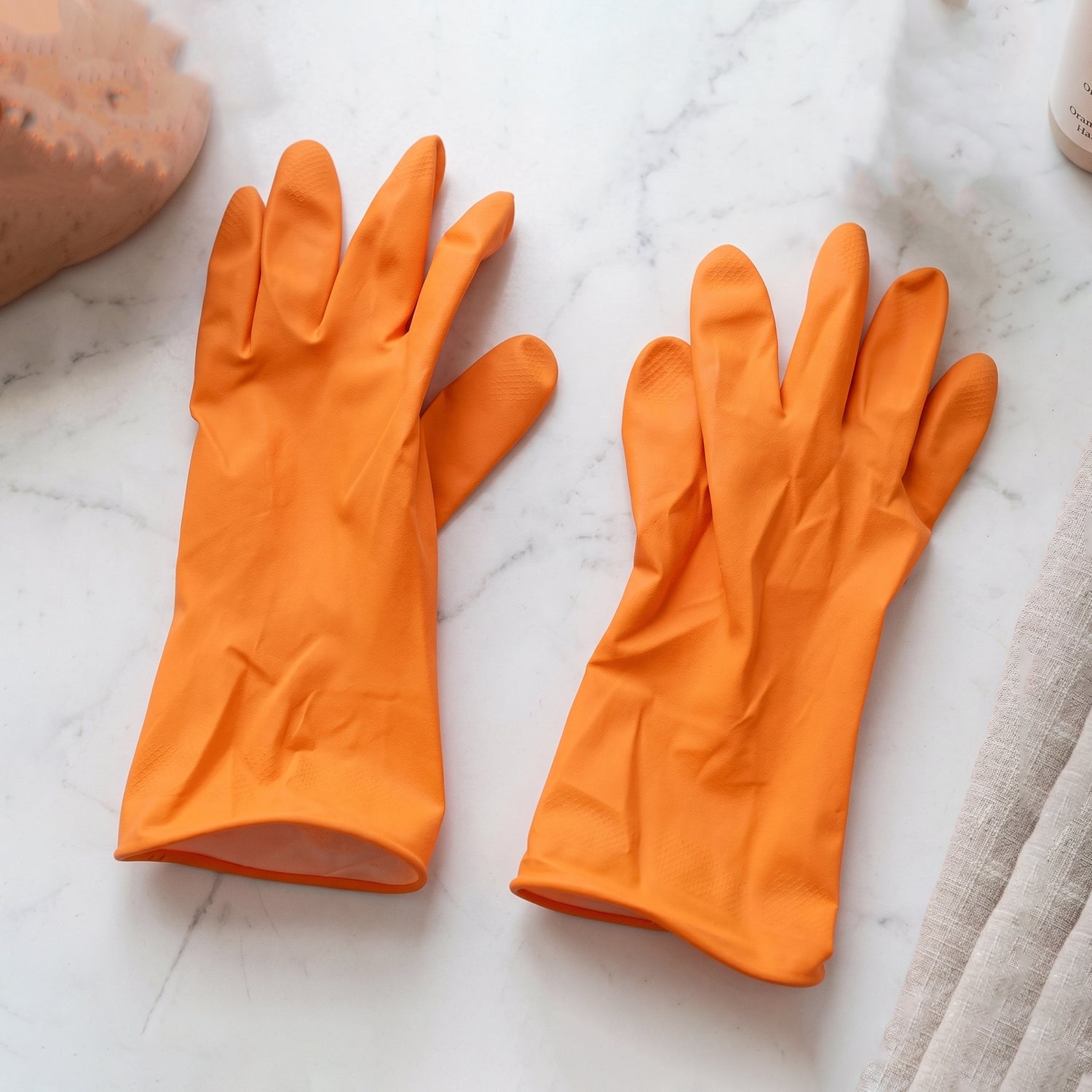 Reusable orange rubber gloves laid out