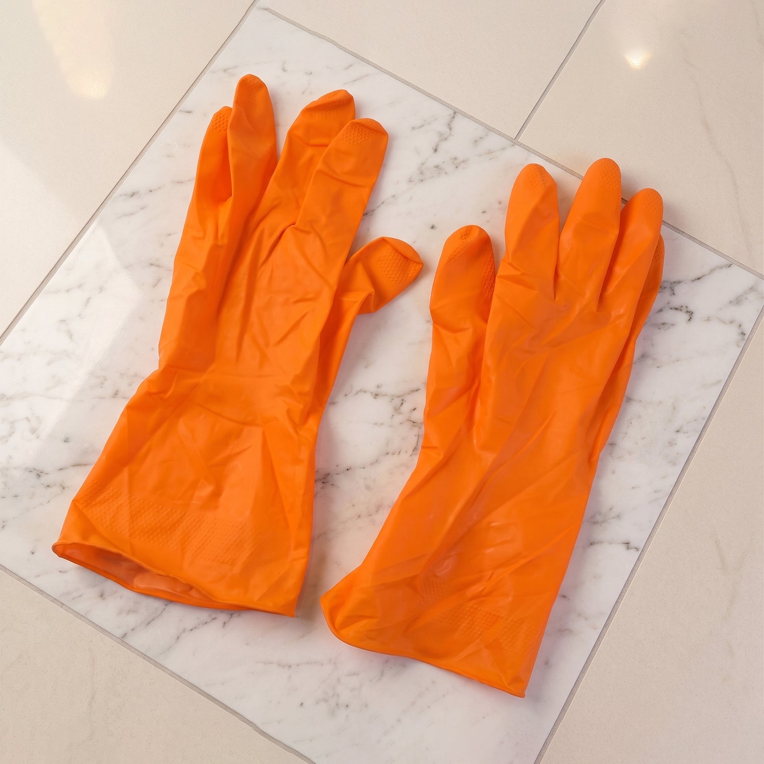 Orange gloves for household cleaning tasks