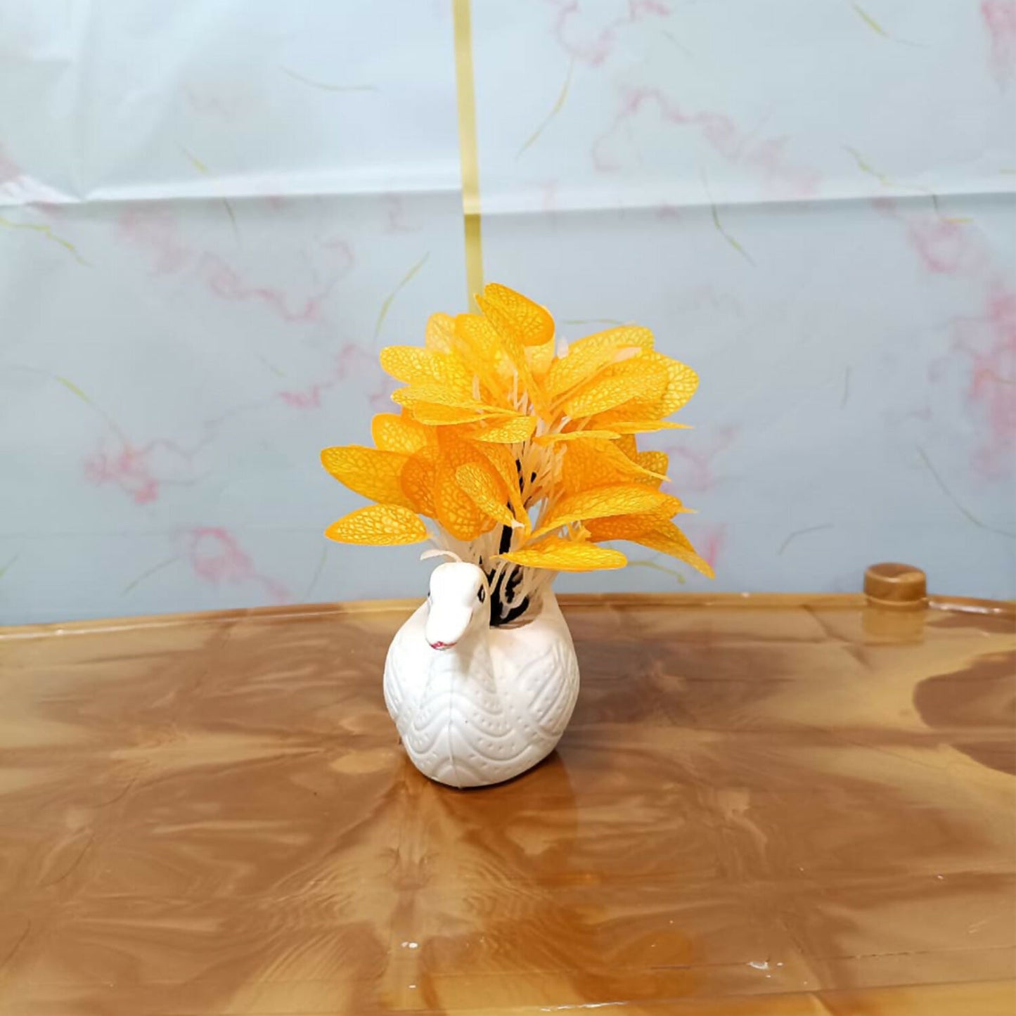 Elegant white ceramic swan vase with orange artificial skeleton leaves for home decor