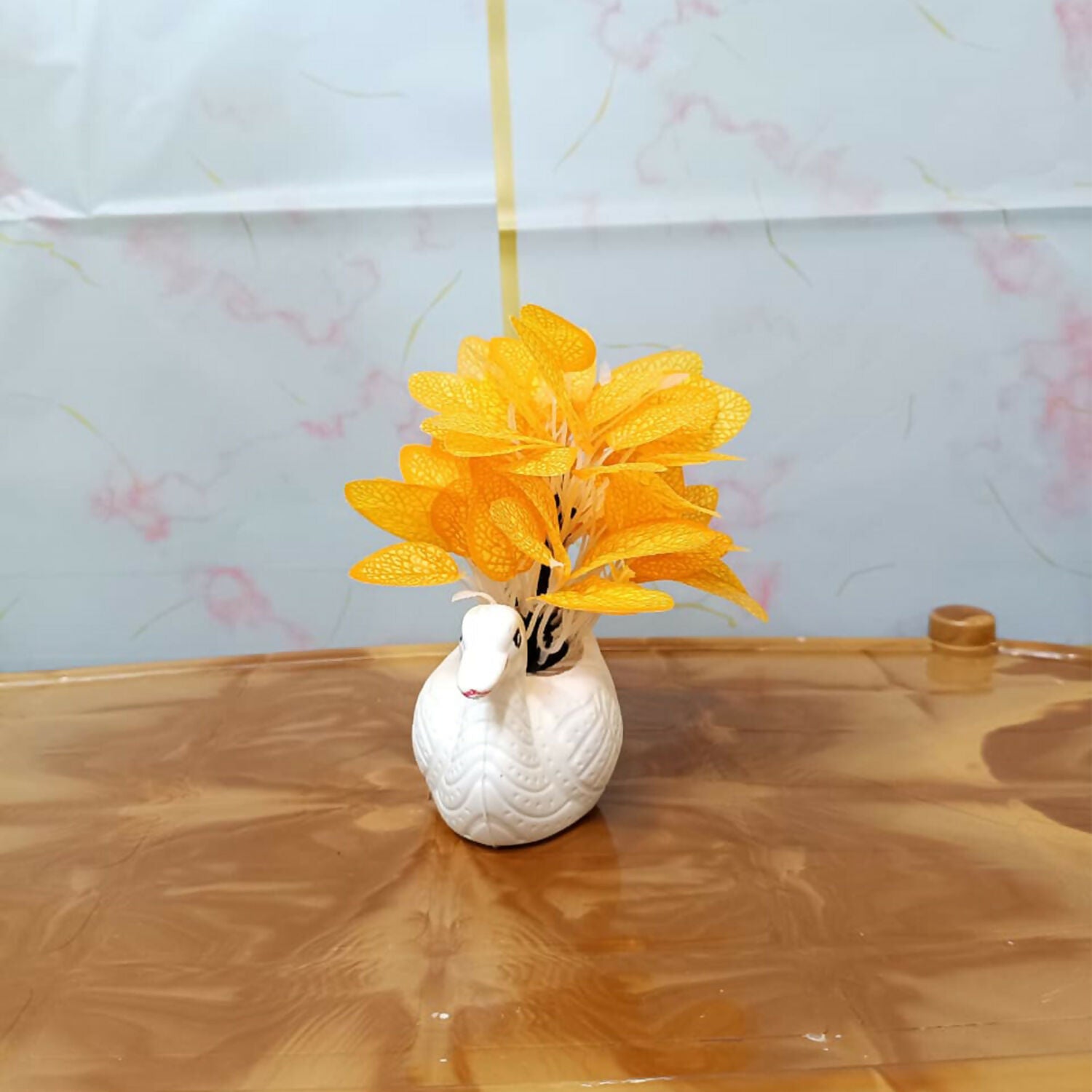 Elegant white ceramic swan vase with orange artificial skeleton leaves for home decor