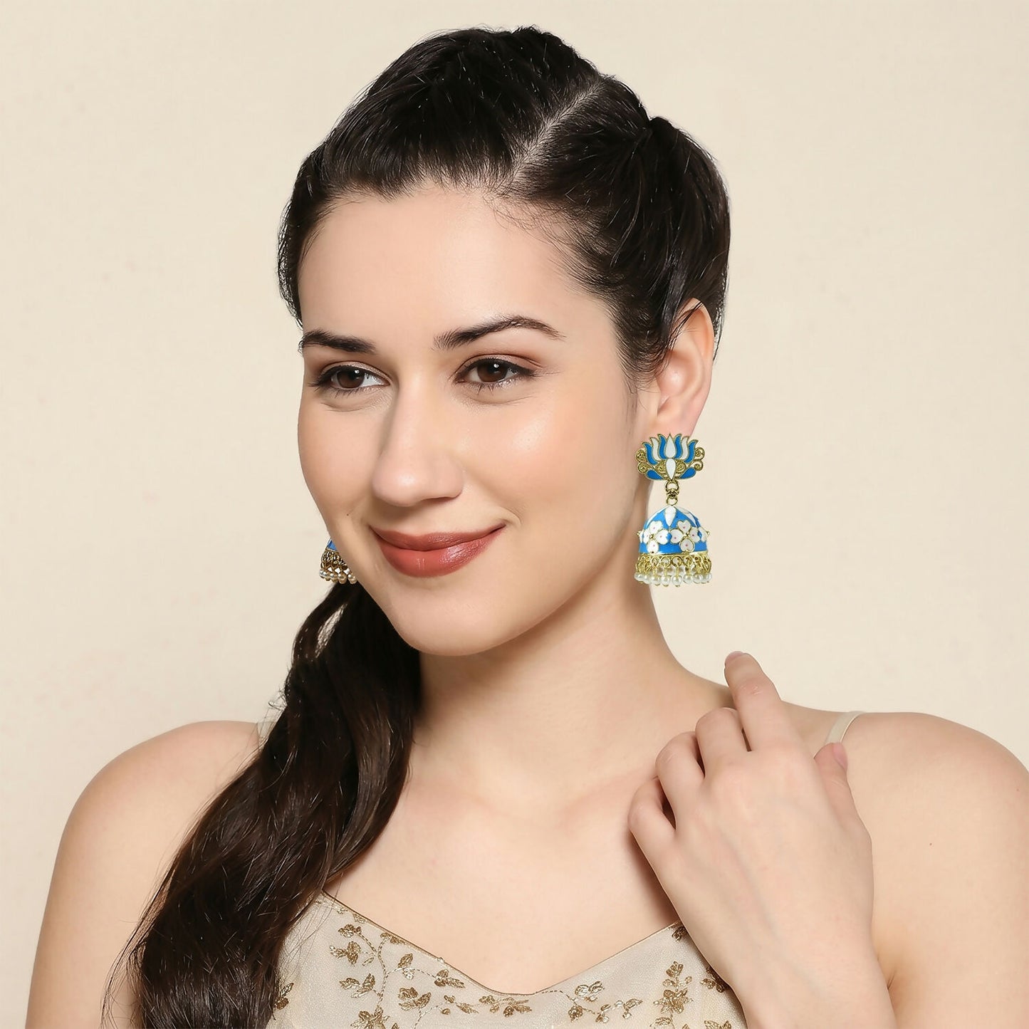 Side angle of blue lotus jhumka earrings showcasing golden detailing