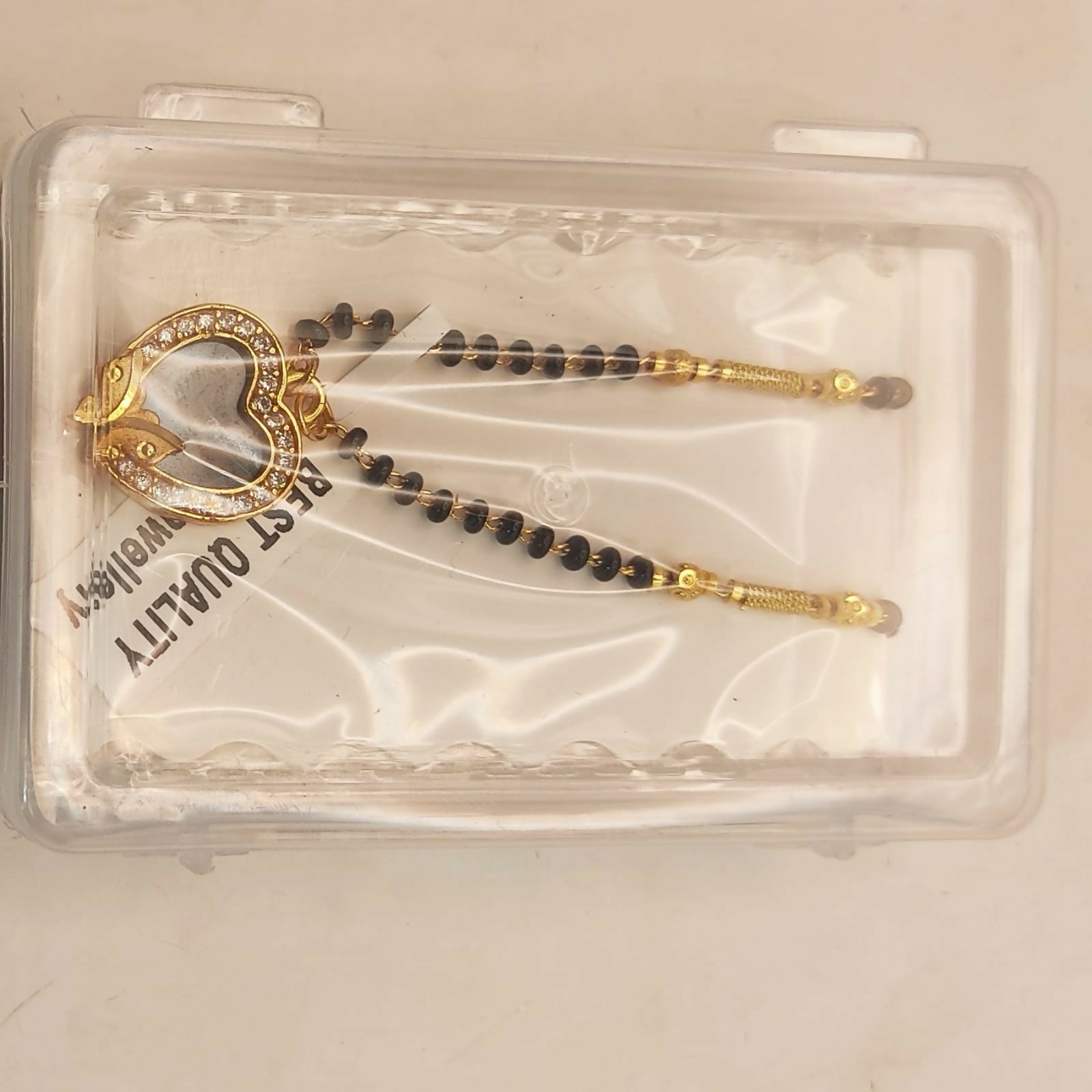 Elegant Mangal Sutra featuring gold-plated heart pendant with black enamel butterfly