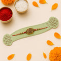 Designer Peacock Motif Rakhi with Peach Beads on Festive Background for Raksha Bandhan