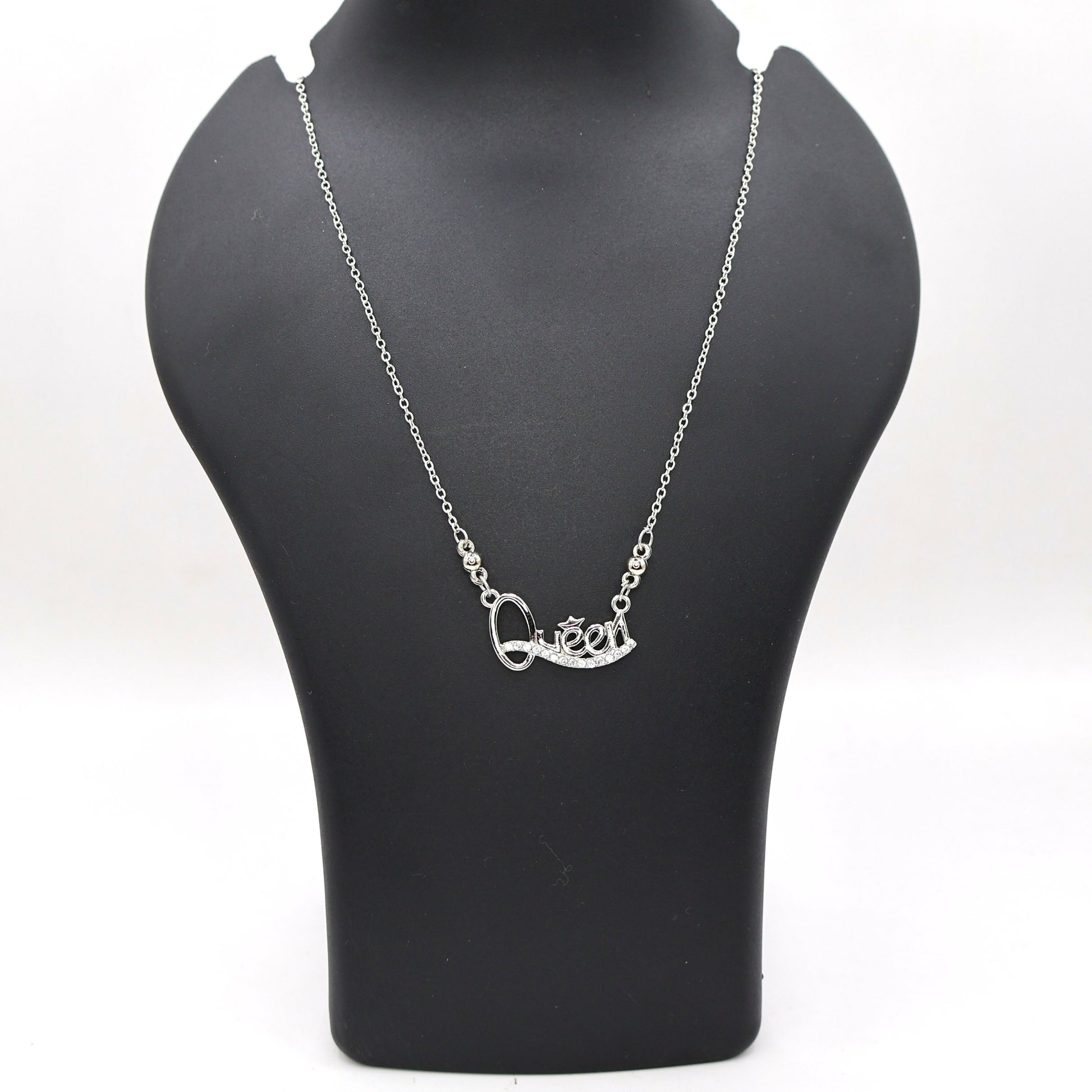 Model wearing Queen pendant necklace in silver tone showcasing sparkling Cubic Zirconia