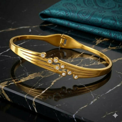 Close-up of floral gold-tone and enamel bracelet details