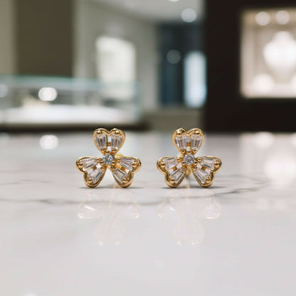 Gold-tone floral stud earrings adorned with Cubic Zirconia stones