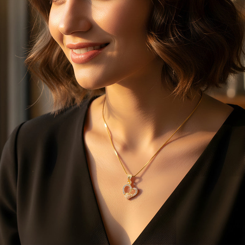 Gold-plated double heart pendant necklace with sparkling crystal accents on outer heart