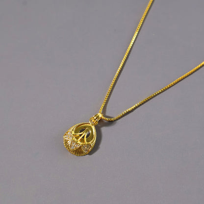 Elegant Gold-Tone Pendant Necklace with Leaf-Inspired Crystal Detailing