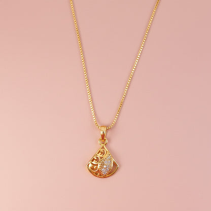 Artistic gold plated pendant necklace with detailed cutwork and leaf accent