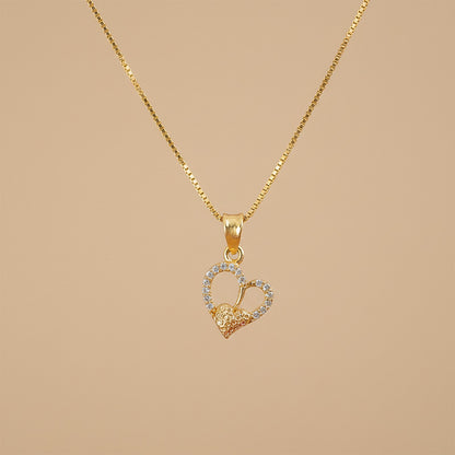 Gold-plated double heart pendant necklace styled with sleek chain on display