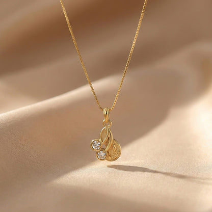 Elegant Gold Pendant Necklace with Dual Crystal Charms and Textured Disc