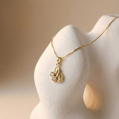 Elegant Gold Pendant Necklace with Dual Crystal Charms and Textured Disc