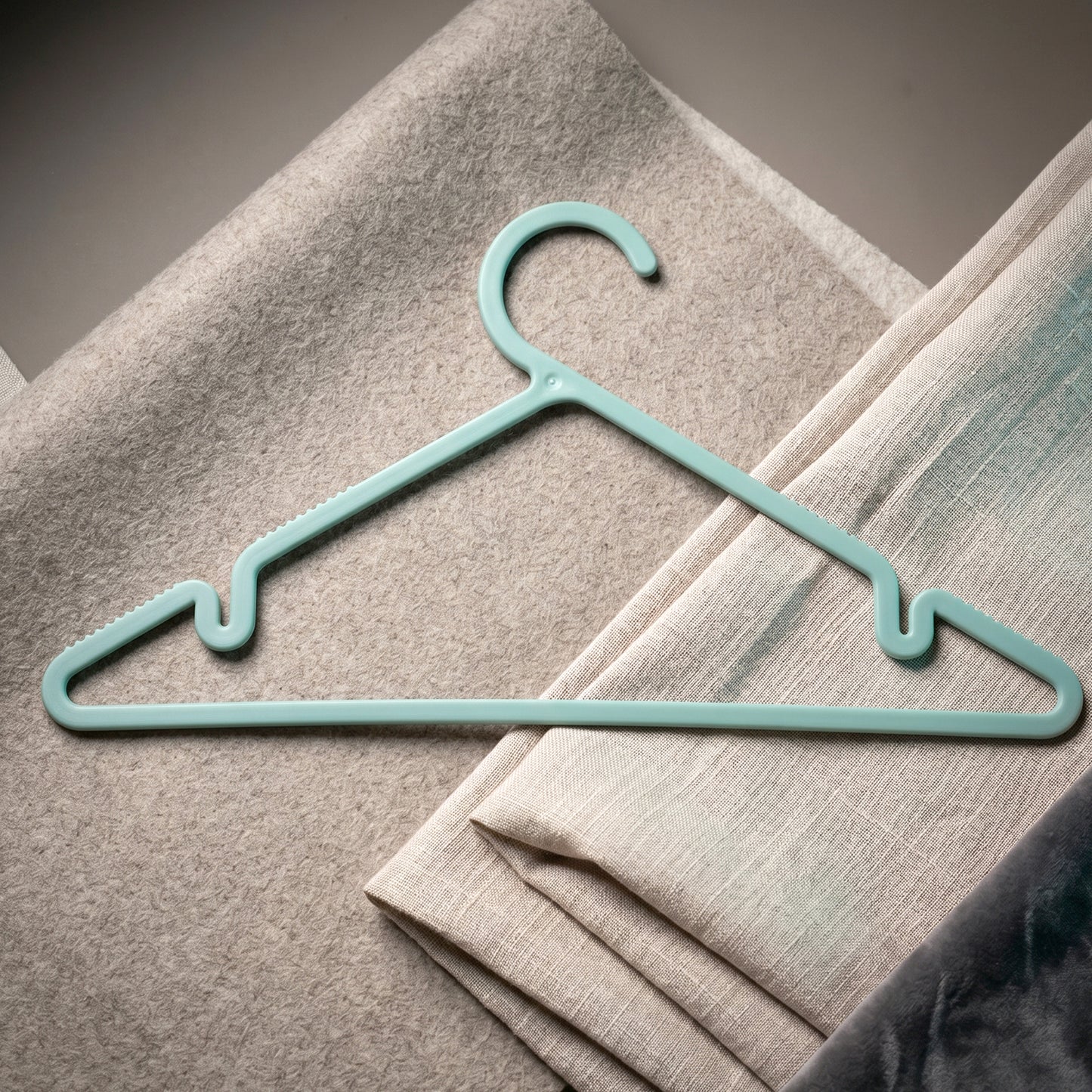 Plastic hanger holding shirt and dress