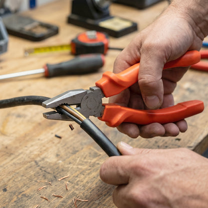 Electrical workshop scene with heavy-duty combination pliers in use