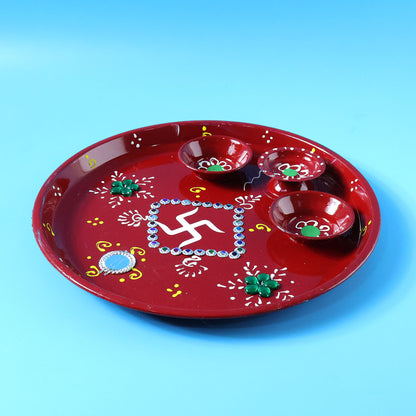 Decorative pooja thali with Ganesha motif used in religious ceremony