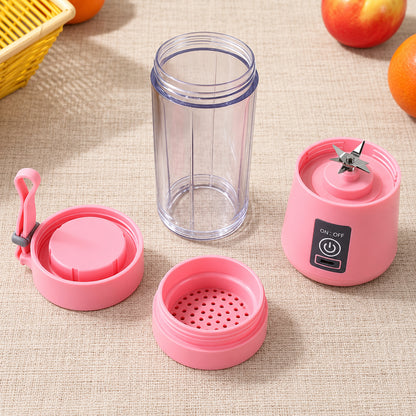 A disassembled pink portable blender with its base, clear jar, lid, and strainer laid out on a beige surface.