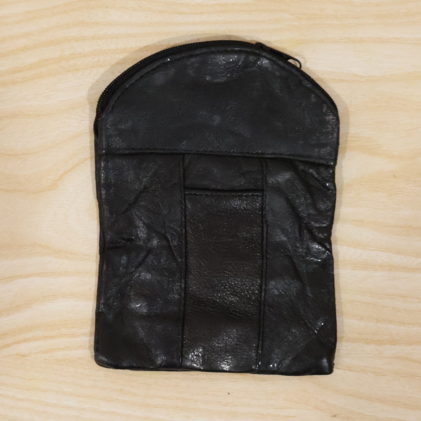 Laying down the black leather mini pouch with its slim profile. Swipeable.