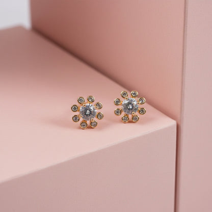 Close-up of flower design stone stud earrings highlighting central and surrounding stones