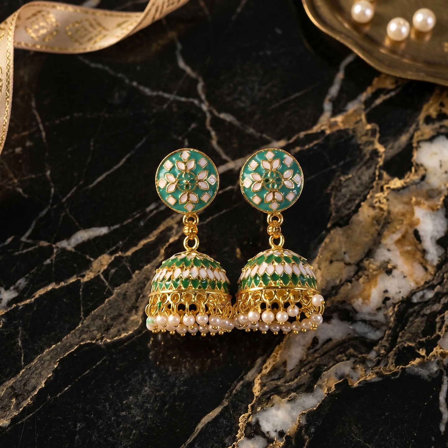 Green floral jhumka earrings with pearl beads close-up