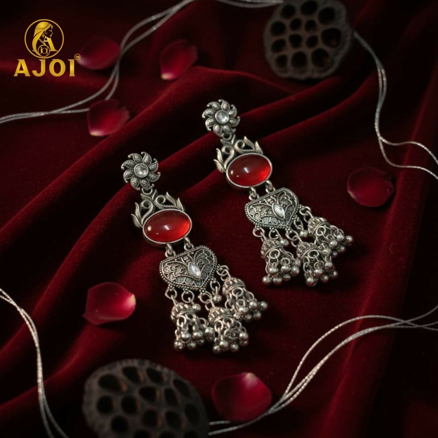 Vintage-Inspired Oxidized Silver Red Stone Jhumka Earrings with Ornate Filigree Design and Cascading Bell Danglers