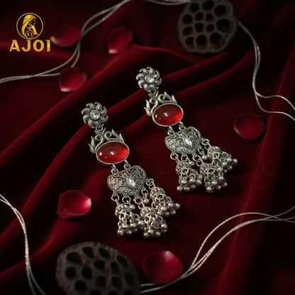 Vintage-Inspired Oxidized Silver Red Stone Jhumka Earrings with Ornate Filigree Design and Cascading Bell Danglers