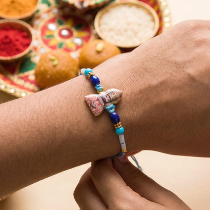 Khatu Shyam Ji devotional Rakhi displayed on a traditional background for Raksha Bandhan.
