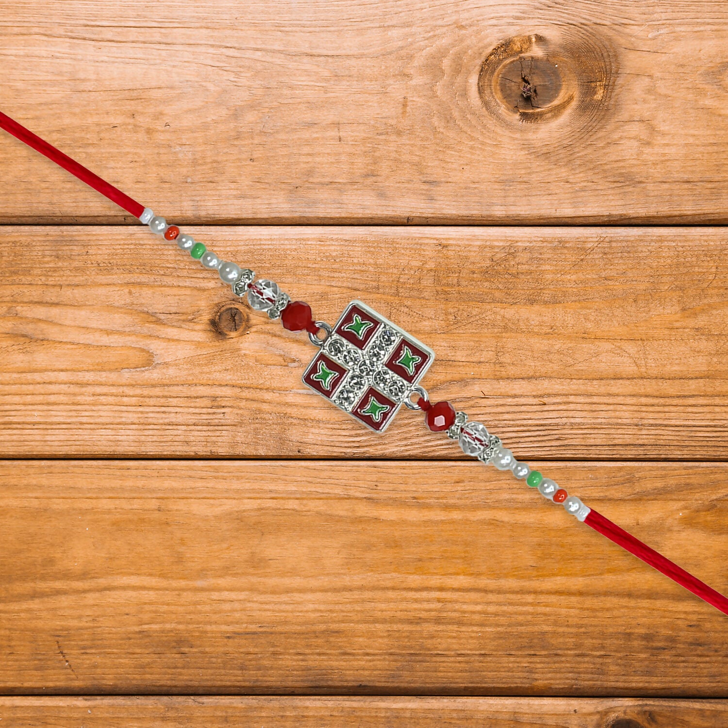 Classic Square Meenakari Rakhi with red thread and vivid accents