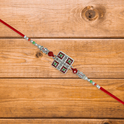 Classic Square Meenakari Rakhi with red thread and vivid accents