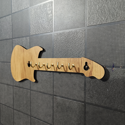 Close-up of wooden guitar key holder hooks and finish