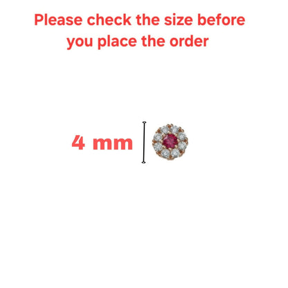 Ruby nose pin set in rose gold with diamond halo, detailed close-up