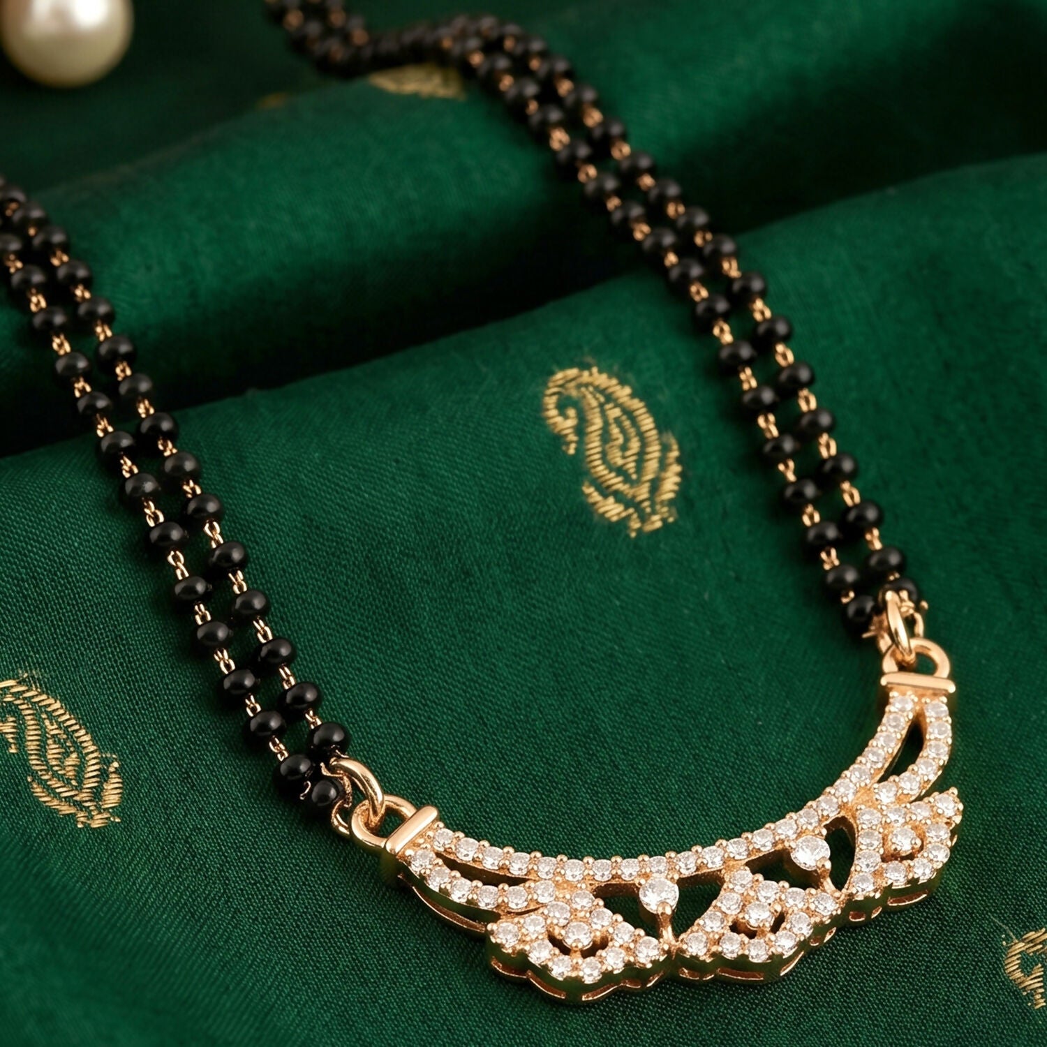 Fashionable mangalsutra with delicate floral CZ motifs and black beads