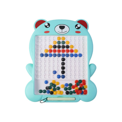 A young child happily playing and creating designs on the Zuppi Bear magnetic drawing board.