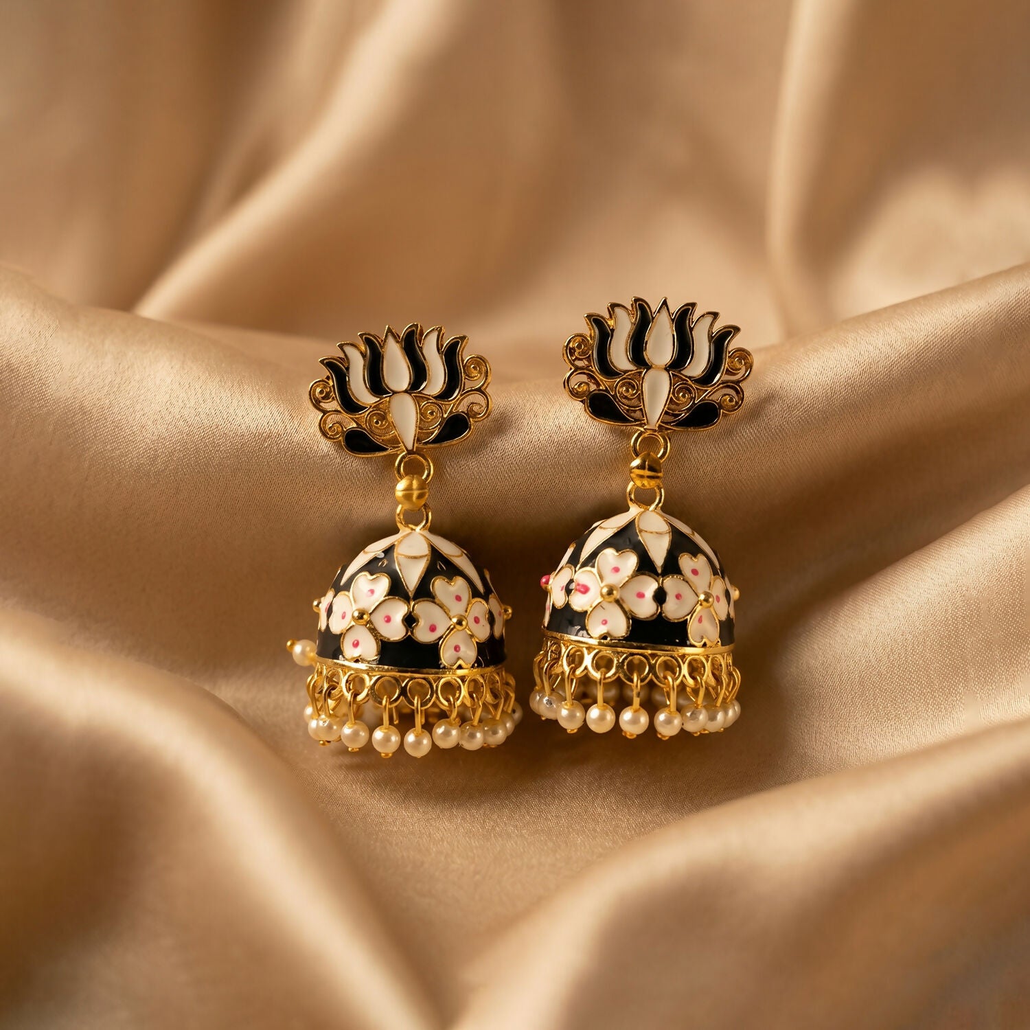 Detailed golden finish on lotus jhumka earrings