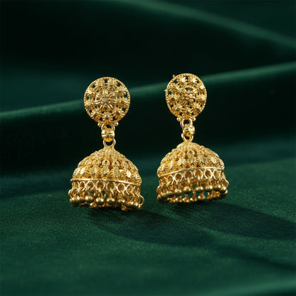 Earrings displayed on traditional fabric background