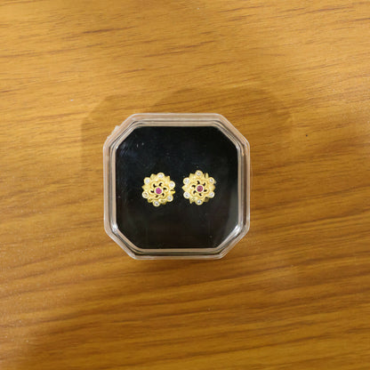 Styled gold floral earrings with multi-stone embellishments