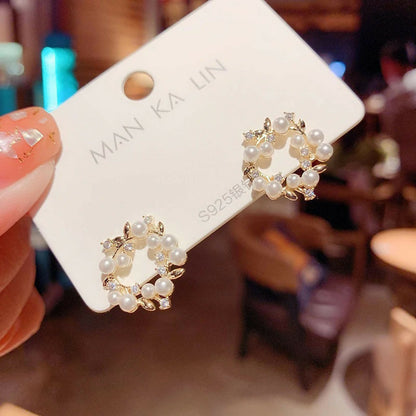 Golden vine pearl stud earrings showcasing delicate design