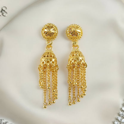 Close-up of intricate design on gold plated jhumka earrings