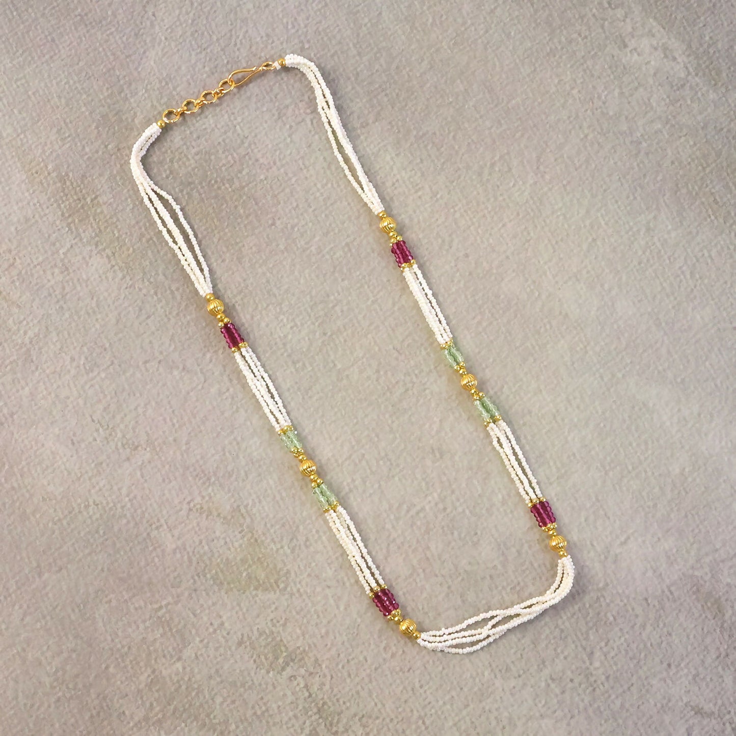 Side view of traditional mala necklace with layered beads and gold accents