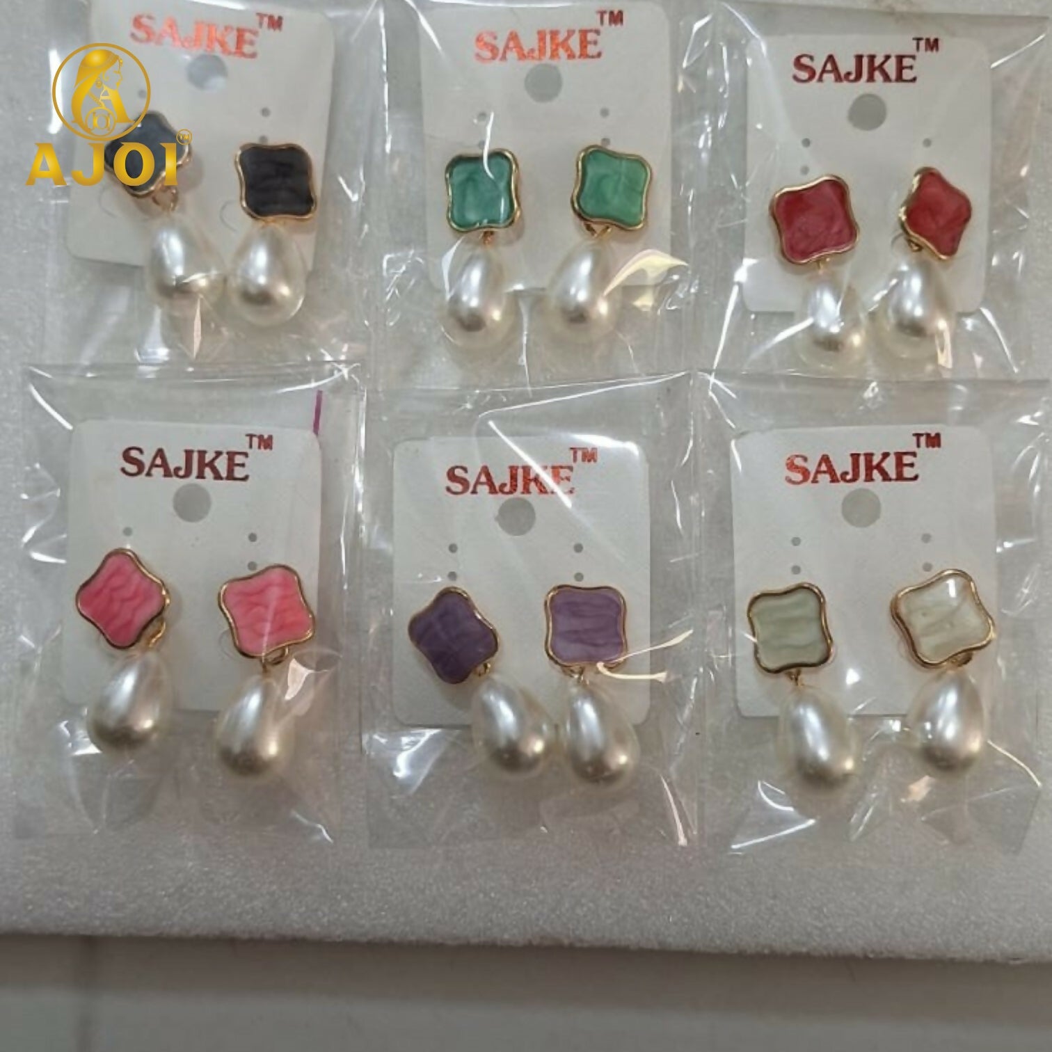 Multiple pearl Tilak earrings with lustrous teardrop pearls and pastel accents