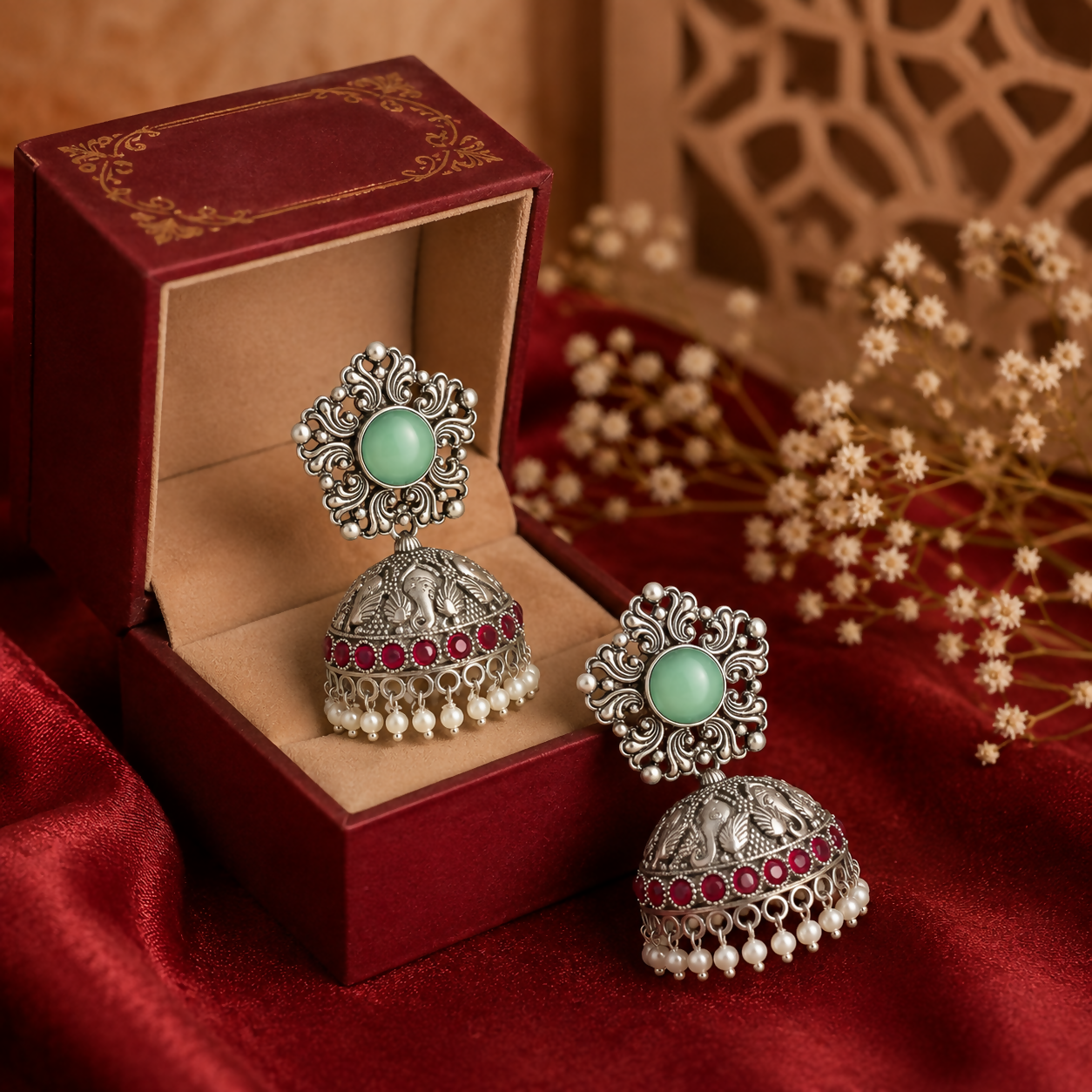 Side view of traditional oxidized silver jhumka earrings with colorful stones