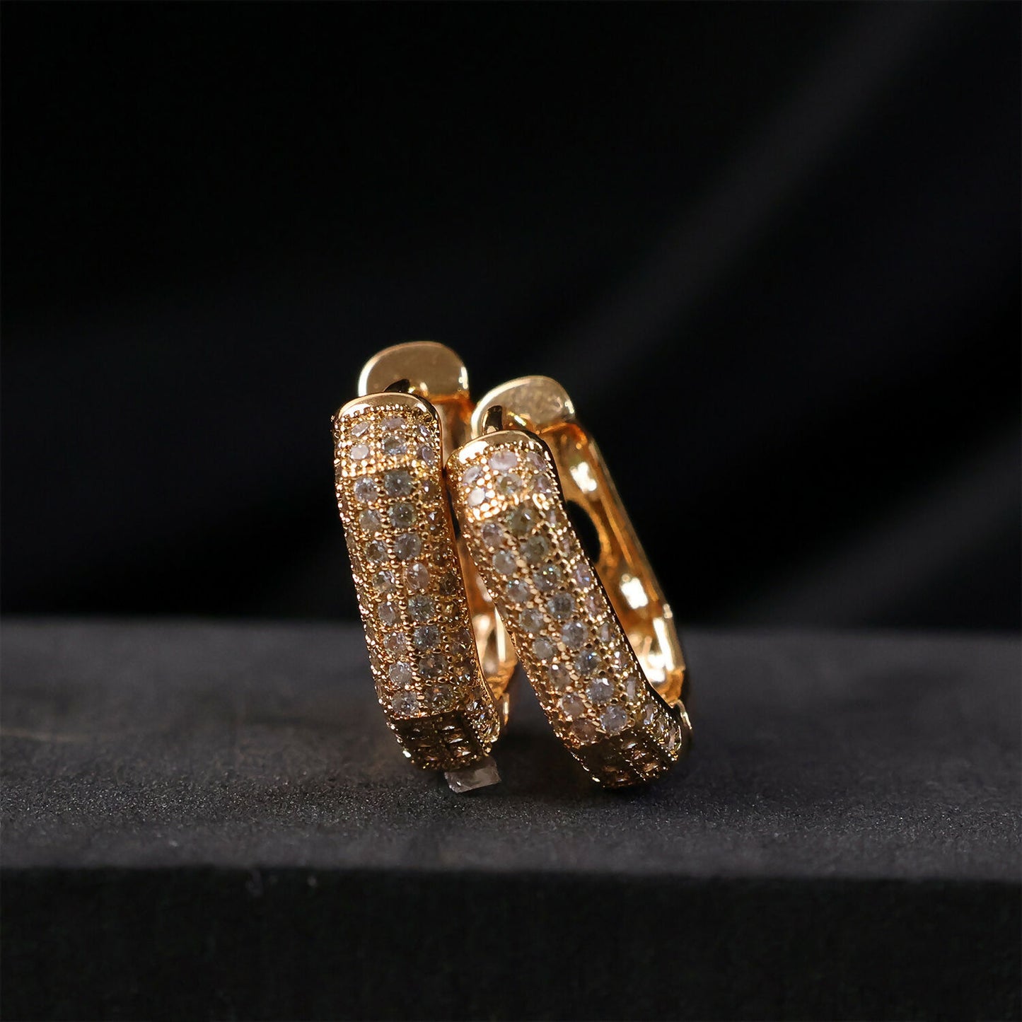 Close-up of elegant CZ hoop earrings shimmering in gold finish