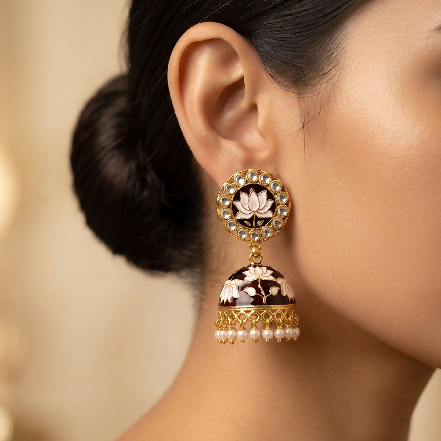 Side view of jhumka earrings with floral detailing and pearl drops