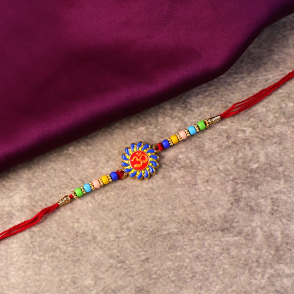 Side angle of Om Designer Rakhi emphasizing traditional thread and beads