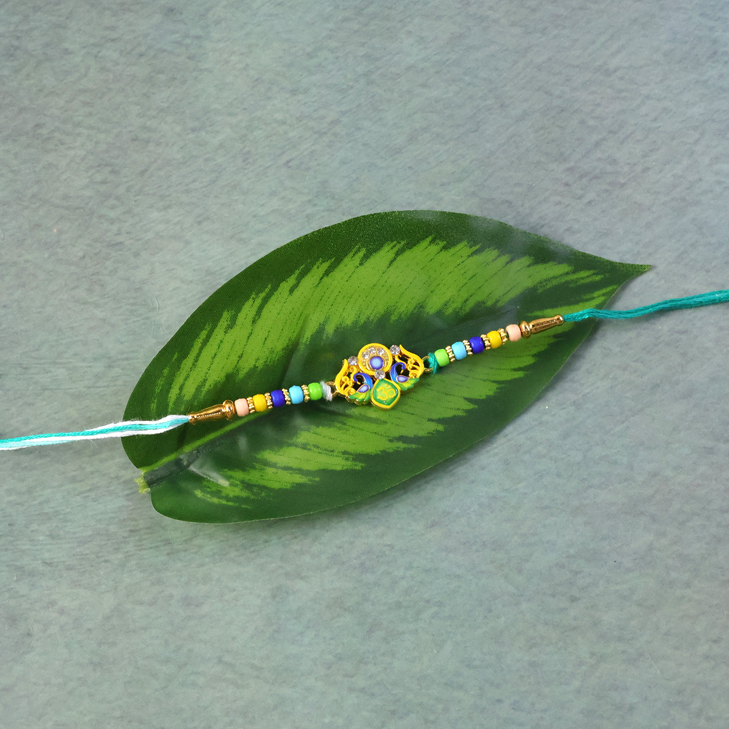 Traditional Rakhi featuring multi-colored beads and yellow thread