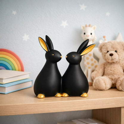 Close-up view of rabbit couple figurine with matte finish and golden detailing