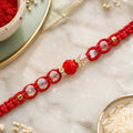 Red Braided Rakhi with a Row of Sparkling Crystal Bead Accents
